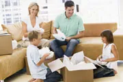 family unpacking boxes in their dream home