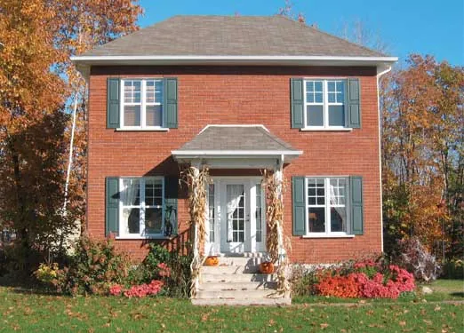 Georgian style home with fall landscaping